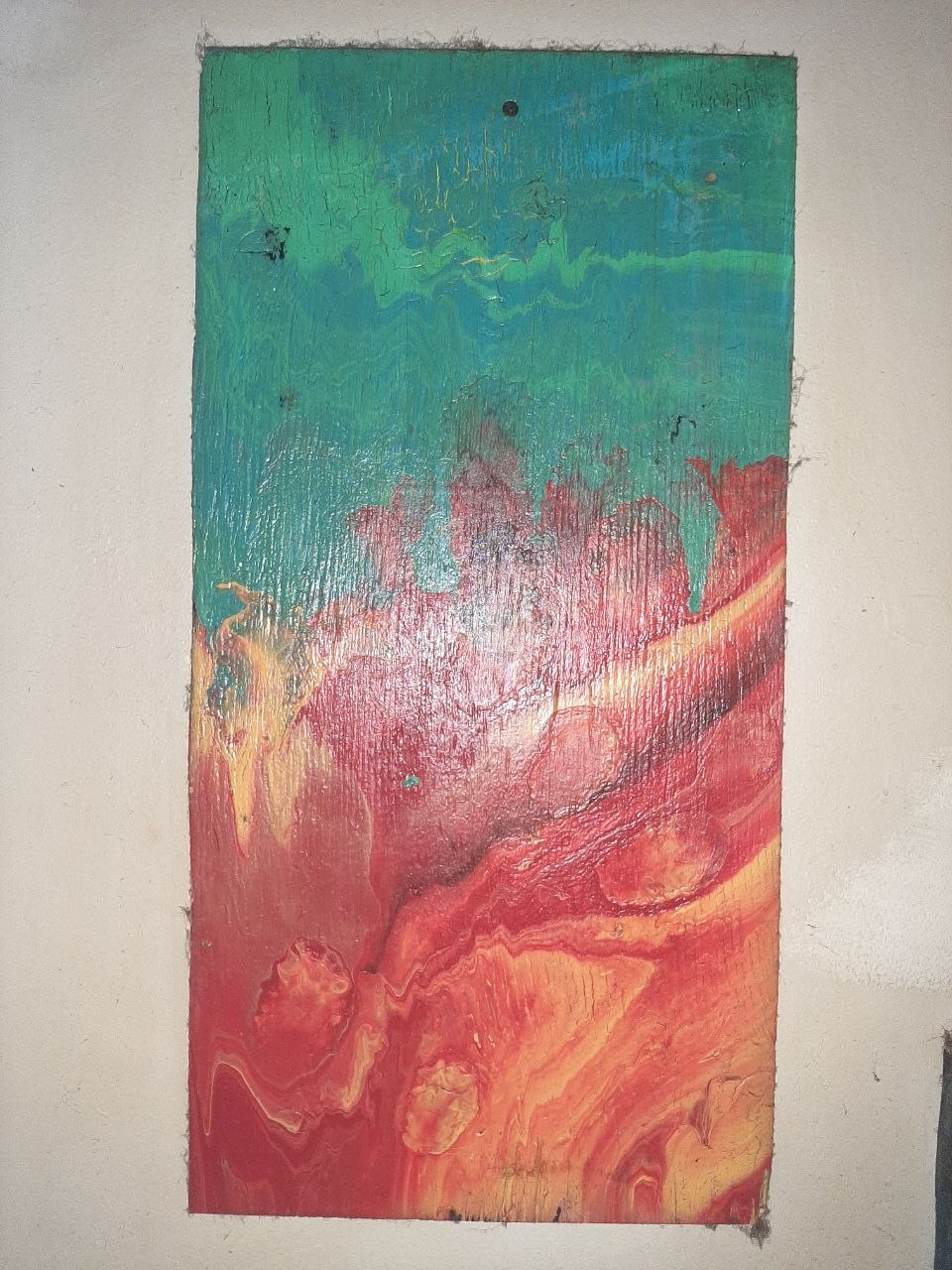 Fluid pour on wood — teal and seafoam green over warm red and rust orange